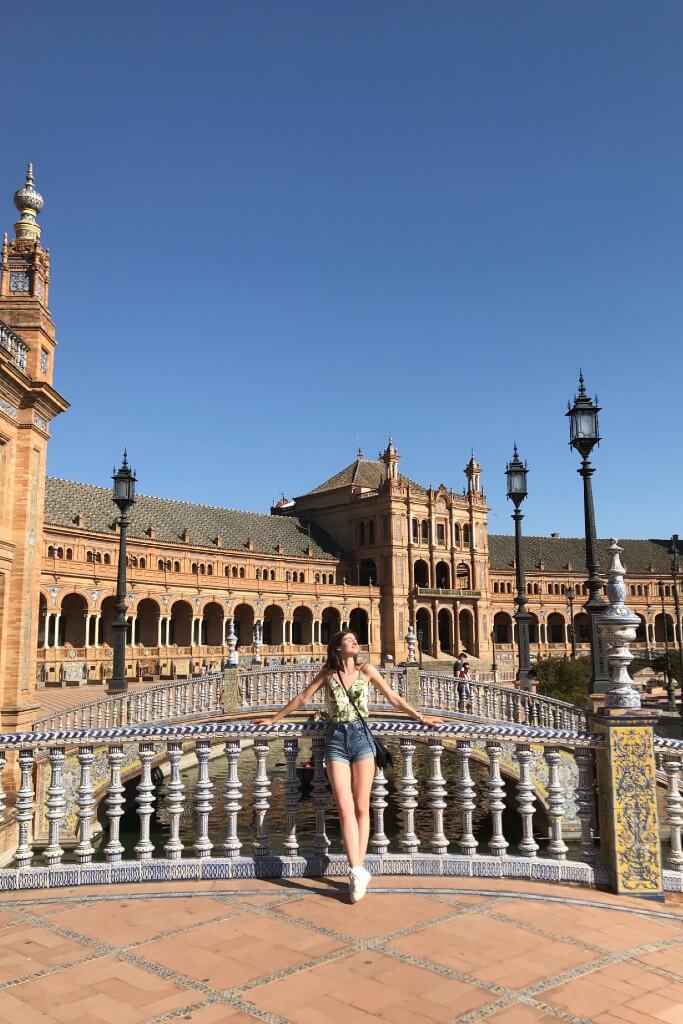 natali wearing a tank top and jean shorts in seville plaza de espagne