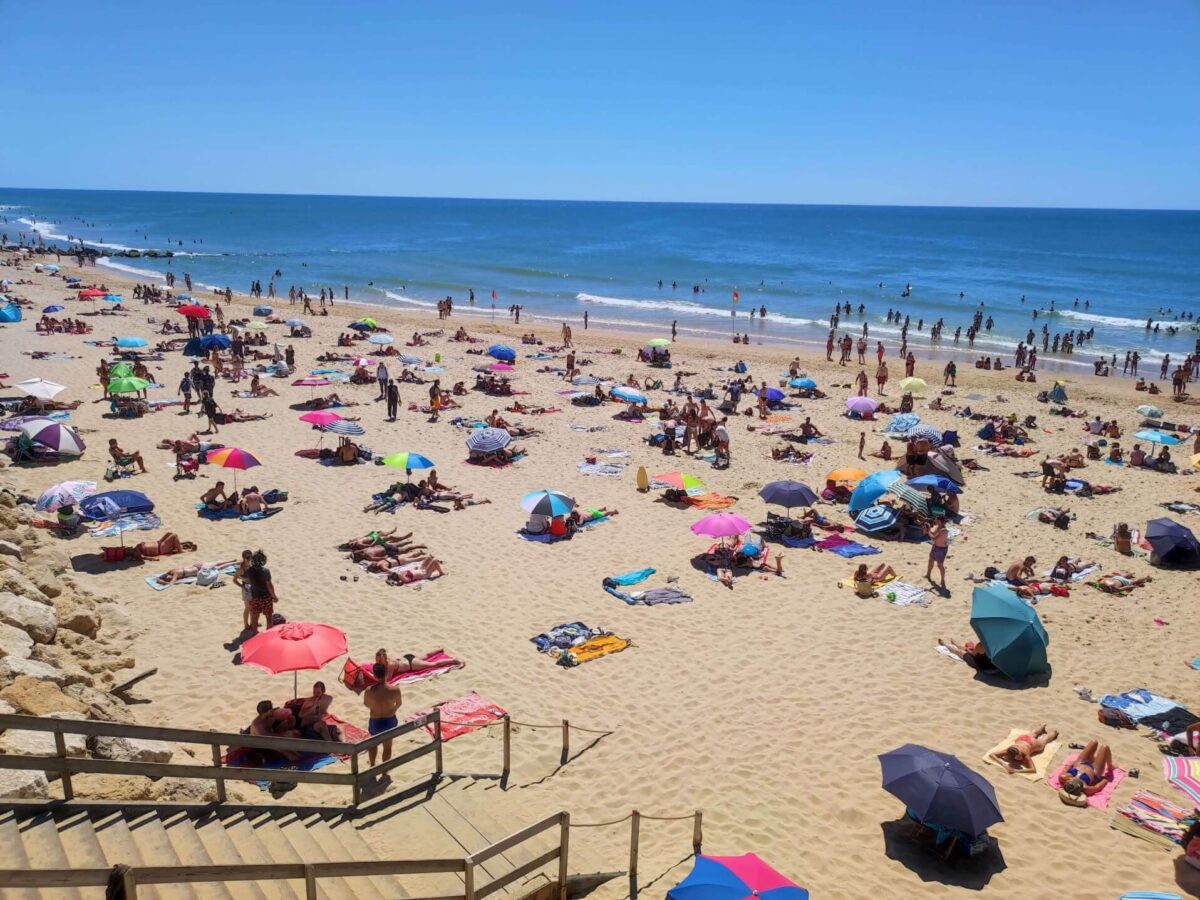 lacanau ocean beach summer with many people and sun umbrellas