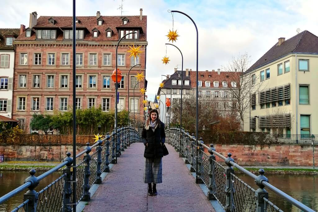 a girl on a bridge on christmas market in strasbourg
