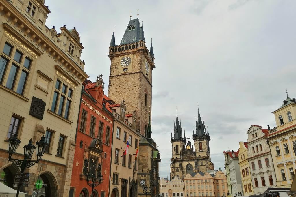prague city centre  with colorful houses and the cathedral hiding behind a row of houses