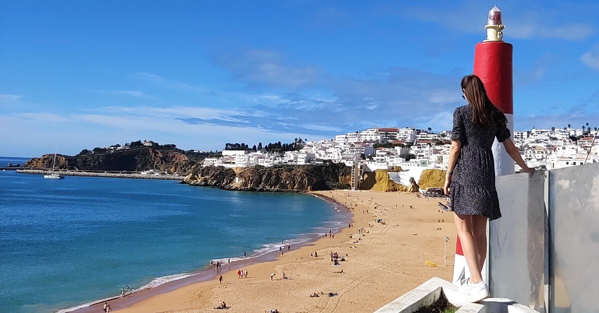 backpacking algarve guide, girl overlooking the beach in albufeira