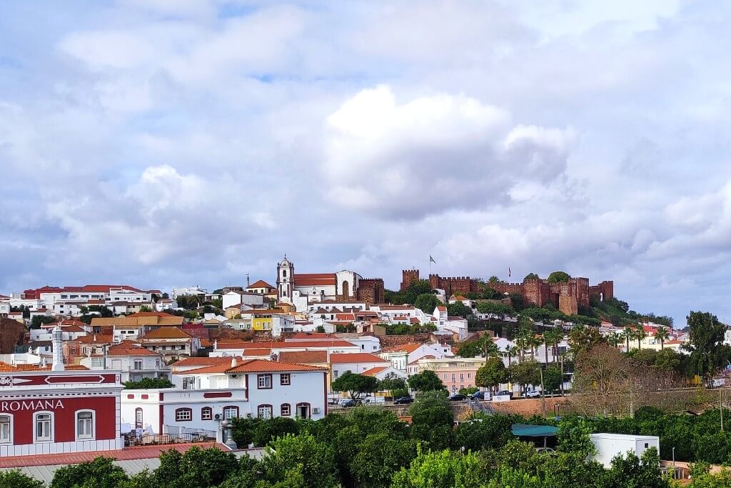 landscape view of silves town and silves castle on the top of the hill