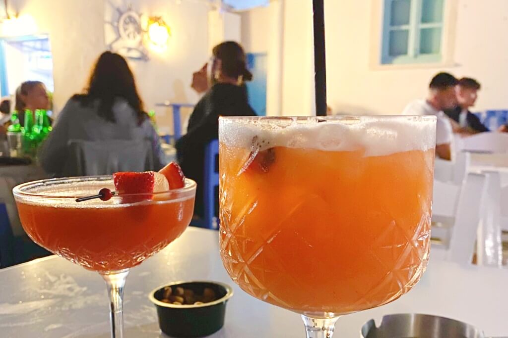a photo of two cocktails, one red and one orange in naoussa paros 