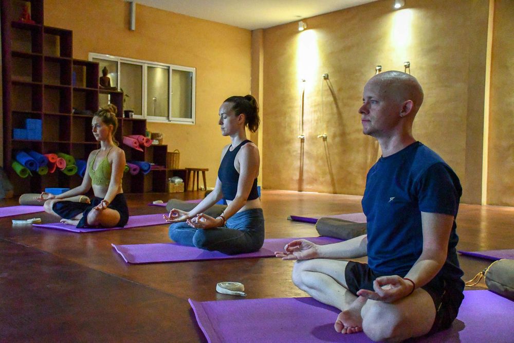 3 people sitting down on a meditation retreat in siem reap