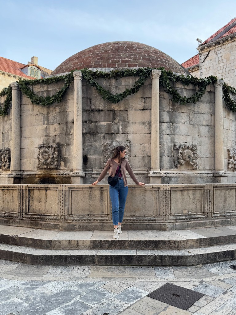 natali standing in front of Onofrio’s Large fountain in dubrovnik old town