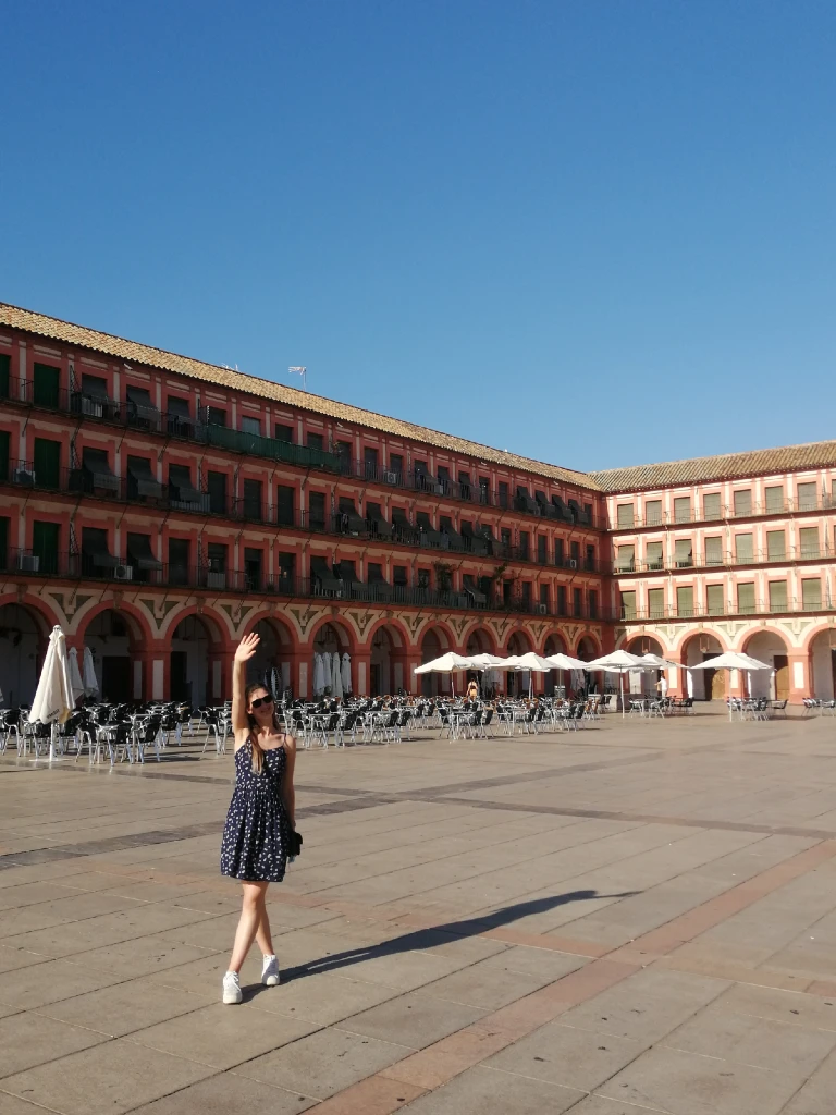 natali standing on a square in cordoba on a sunny summer day