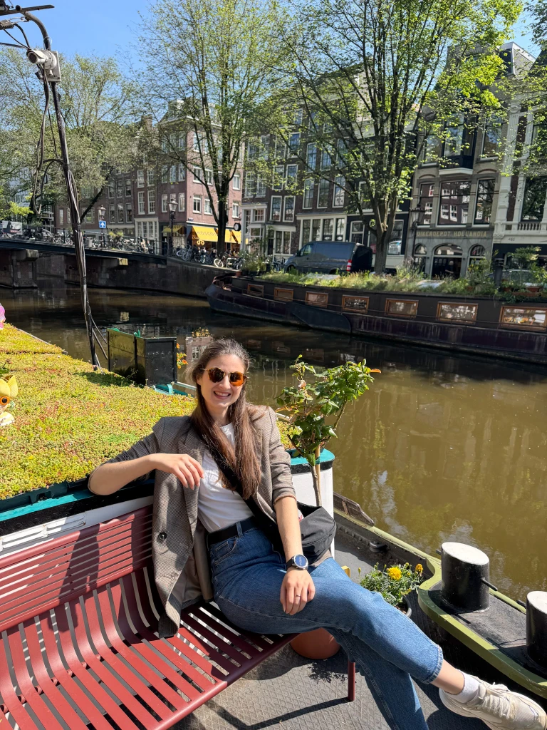 natali sitting on a bench on the roof of a house boat museum in amsterdam